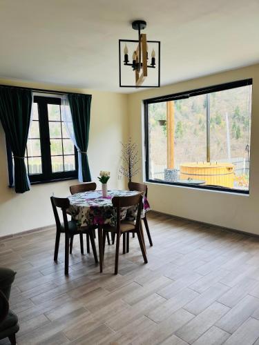 a dining room with a table and chairs at Woodlandia Resort Borjomi in Borjomi