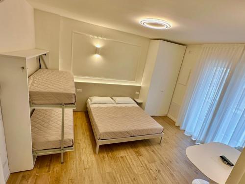 Postel nebo postele na pokoji v ubytování Appartamenti Luigi e Carla