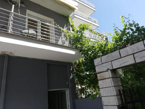 a building with a balcony and a fence at Aktis Sea View Studios in Perea