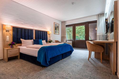 Postel nebo postele na pokoji v ubytování Hotel Zur Heidschnucke - Spa & Nature Resort
