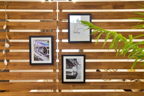 a wall with four framed pictures on it at アーモンド石垣 in Tunugusuku