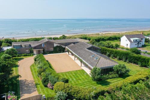 an aerial view of a house with the beach at Vegan Seafront Retreat & Yoga Studio in West Wittering in West Wittering