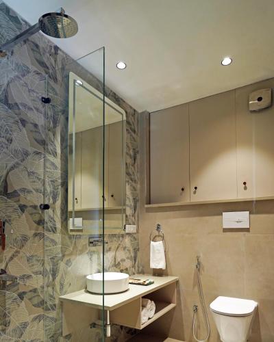 a bathroom with a toilet and a sink and a shower at Hotel River Heaven by TNT Ventures in Rishīkesh