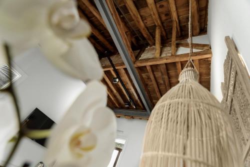 a room with a ceiling with a broom hanging from it at Hotel La Casa de Los Mosaicos by Maxi Hoteles in Granada