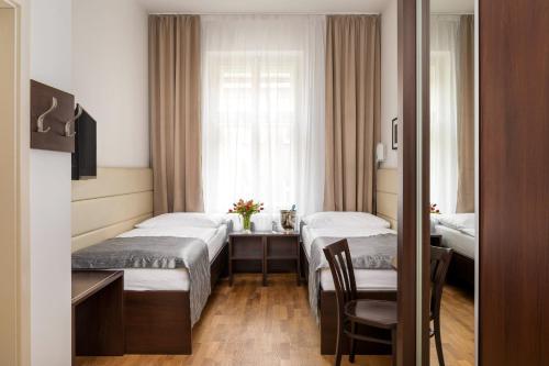 Postel nebo postele na pokoji v ubytování Hotel Unique