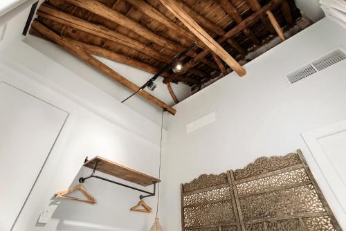 a room with white walls and wooden beams at Hotel La Casa de Los Mosaicos by Maxi Hoteles in Granada