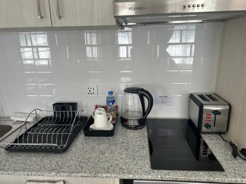 a kitchen counter with a blender and a toaster at Room in La Grande Residences in Angeles