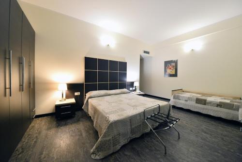 a bedroom with a large bed and two tables at Hotel Ferrari in Chiavari