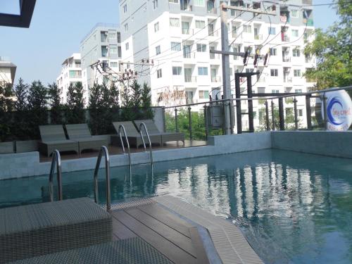 a swimming pool in front of a building at Sea Crest by Jomtien in Jomtien Beach