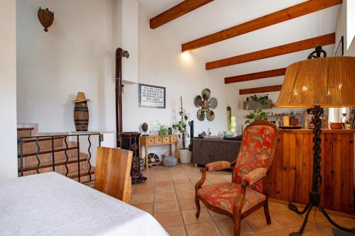 a living room with a table and a chair at La Villa du bonheur in Puy-Saint-Martin