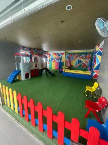 a play room with a playground and a play house at Antel Spa Residences 2505 in Manila