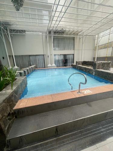 a large swimming pool in a building at Antel Spa Residences 2505 in Manila