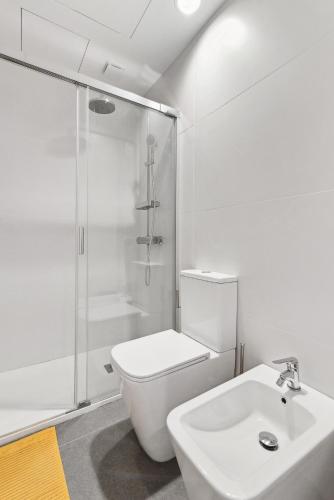 a bathroom with a shower and a toilet and a sink at Las Dunas de Santa Catalina Boutique House in Las Palmas de Gran Canaria