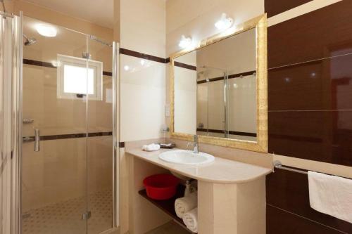 a bathroom with a sink and a shower at Praslin Paradise in Baie Sainte Anne