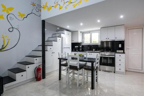 a kitchen with a table and chairs in a room at Sophia's Apartment in Kalamata