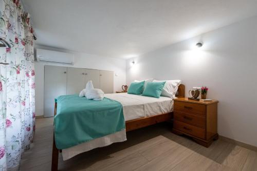 a bedroom with a bed with blue and white sheets at Sophia's Apartment in Kalamata