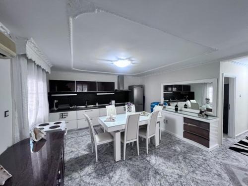a kitchen with a table and chairs in a room at Narcis House in Thessaloniki