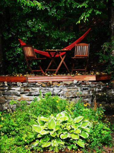 two chairs and a hammock in a garden at Srub Pod Lípou - Skryje in Skryje