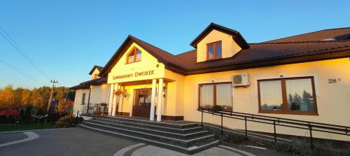 a yellow building with stairs in front of it at Lawendowy Dworek in Bałtów