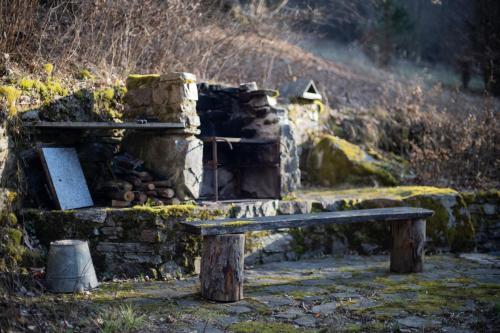 a wooden bench sitting in front of a stone building at Srub Pod Lípou - Skryje in Skryje