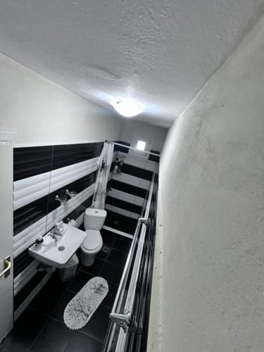 a bathroom with a toilet and a sink at Narcis House in Thessaloniki
