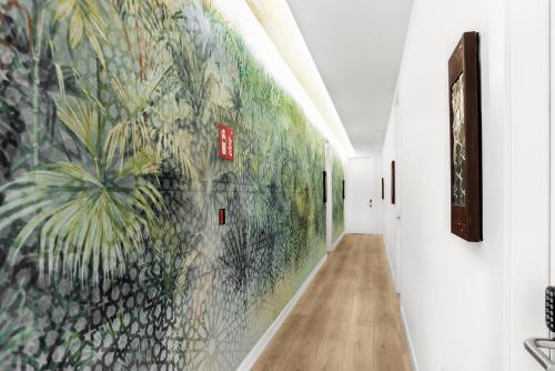 a hallway with a mural on the wall at Hotel La Casa de Los Mosaicos by Maxi Hoteles in Granada
