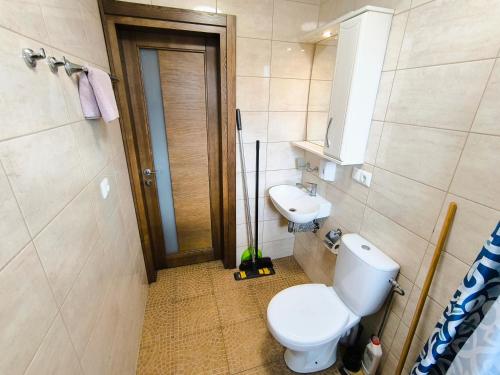 a bathroom with a toilet and a sink at Karkle Beach Suites in Karklė