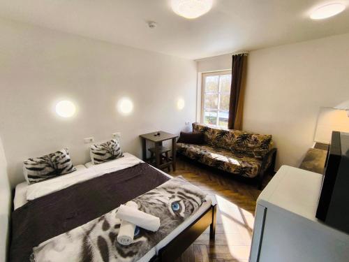 a room with a bed and a couch in it at Karkle Beach Suites in Karklė