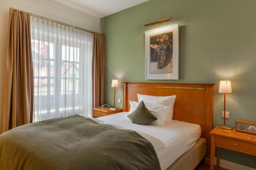 Ένα ή περισσότερα κρεβάτια σε δωμάτιο στο Romantik Hotel Kleber Post