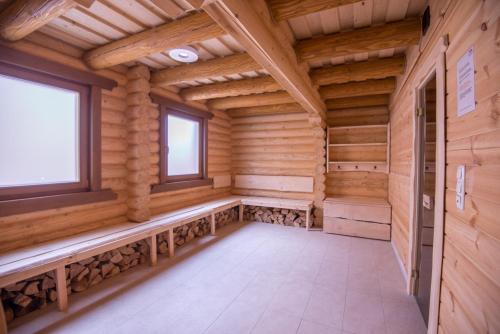 an empty sauna with wooden walls and windows at Drei Bären Hotel & Apartments in Aichach