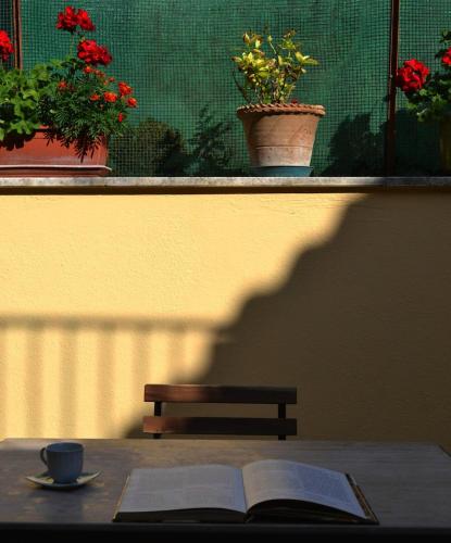 an open book on a table with a cup of coffee and a bench at Casa Anna Cerasuolo - intera casa indipendente in borgo in Cerasuolo