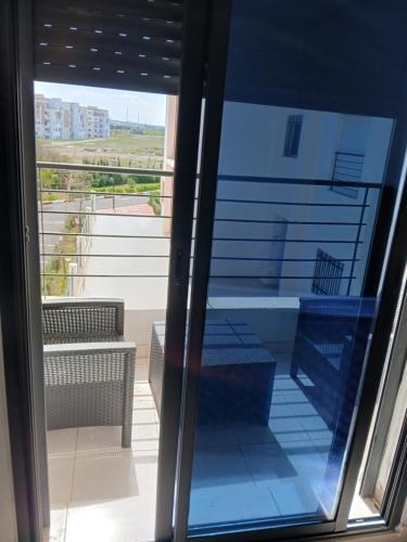 a view through a glass window of a balcony at Tanger Beach coralia in Tangier