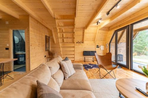 a living room with a couch and a table at Mountain homes Durmitor 2 in Žabljak