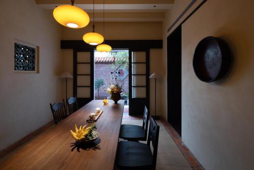 a dining room with a long table and chairs at 巷里栖墅民宿 in Quanzhou