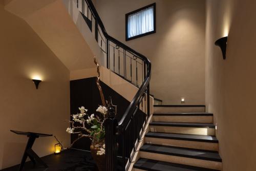 a staircase in a house with a vase of flowers at 巷里栖墅民宿 in Quanzhou