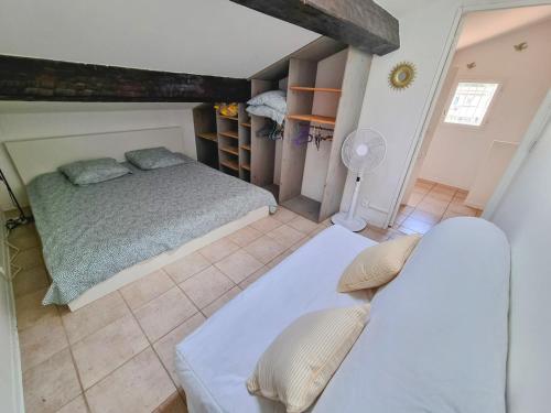 - une chambre avec 2 lits et un ventilateur dans l'établissement Hyères 2-room terrace balcony, à Hyères