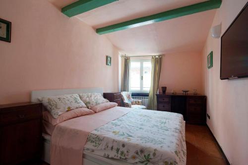 a bedroom with a bed and a tv in it at Casa al Castello in Lerici