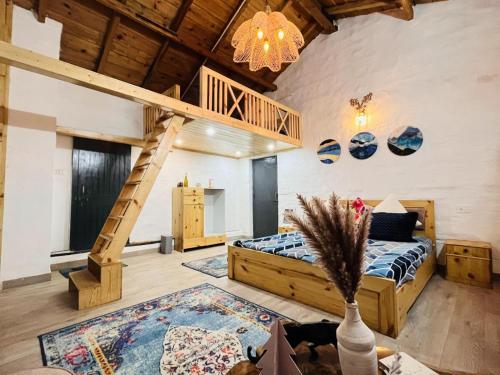 a bedroom with a bunk bed and a staircase at Tatsaaraa Kavan in Rāmgarh