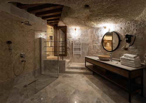 a bathroom with a shower and a sink and a mirror at Henna Hotel-Adults Only in Goreme