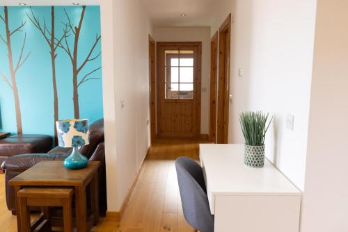 a living room with a couch and a table at Botaira, Shetland Islands in Easter Quarff