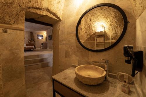 a bathroom with a stone sink and a mirror at Henna Hotel-Adults Only in Goreme