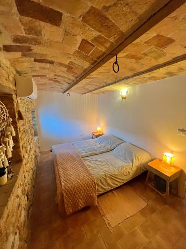 a bedroom with a bed with two lamps on it at Casale Fontessa in Citta' Sant'Angelo