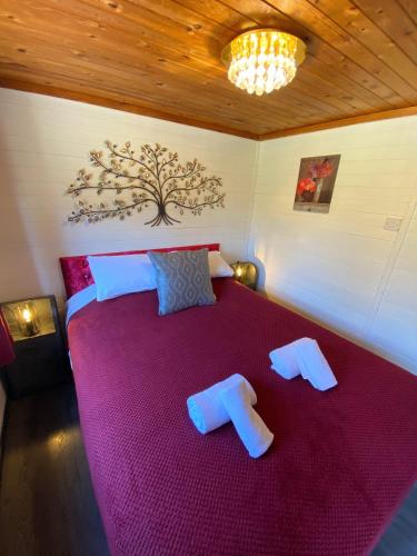a bedroom with a large red bed with two pillows at Otter 2 HuntersMoon- Warminster-Wiltshire-Bristol in Warminster