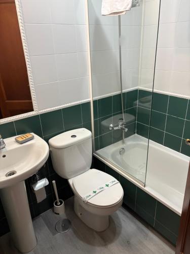 a bathroom with a toilet and a sink and a shower at Hotel Real in Santiago de Compostela