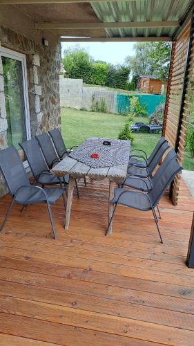 a patio with a table and chairs on a deck at Apartmány Domaša Poľany in Holčíkovce