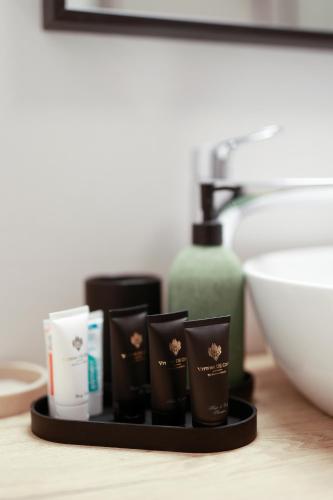 a tray with soap and other bathroom products on a counter at Ars Vivendi in Opatija