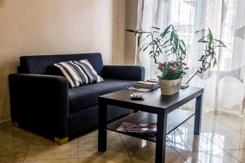 a living room with a blue couch and a table at San Pietro's Home - Guesthouse in Rome