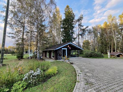a small pavilion in a park with a brick road at Rozes Oga, Tūrisma mītnes namiņš in Ieriķi