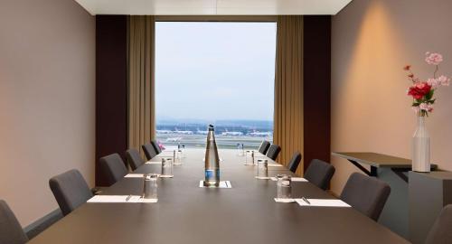 a conference room with a long table with a missile on it at Radisson Blu Hotel Zurich Airport in Kloten