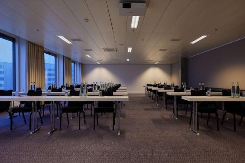 a conference room with tables and chairs in a building at Radisson Blu Hotel Zurich Airport in Kloten